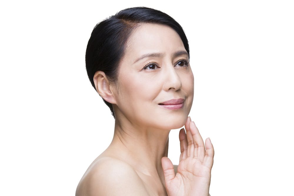 Close-up of a woman's face showing smooth skin, light makeup, and fine lines, highlighting the subtle effects of microneedling for wrinkles, with a neutral expression and a soft focus background.